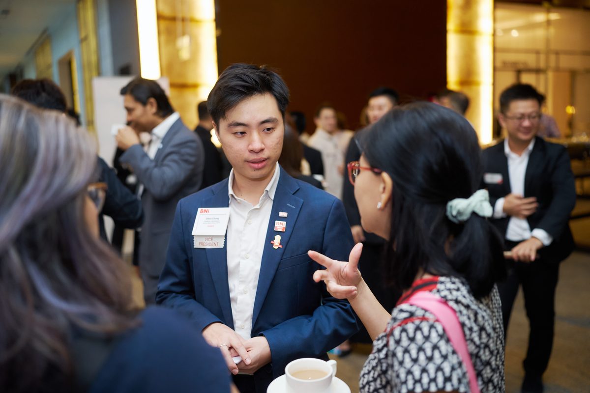 Two members in conversation over coffee before the meeting starts