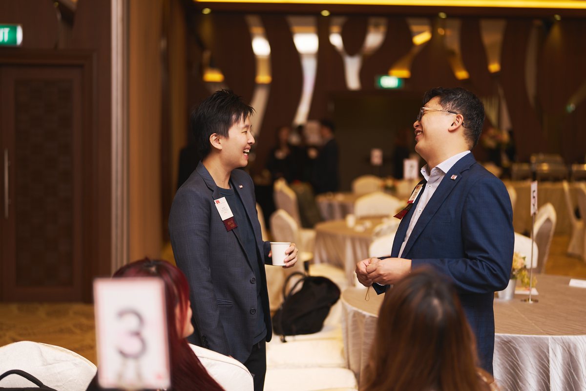 Two members deep in conversation beside the breakfast tables
